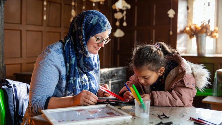 Family activity in the indoor craft room at East Riddlesden Hall, West Yorkshire